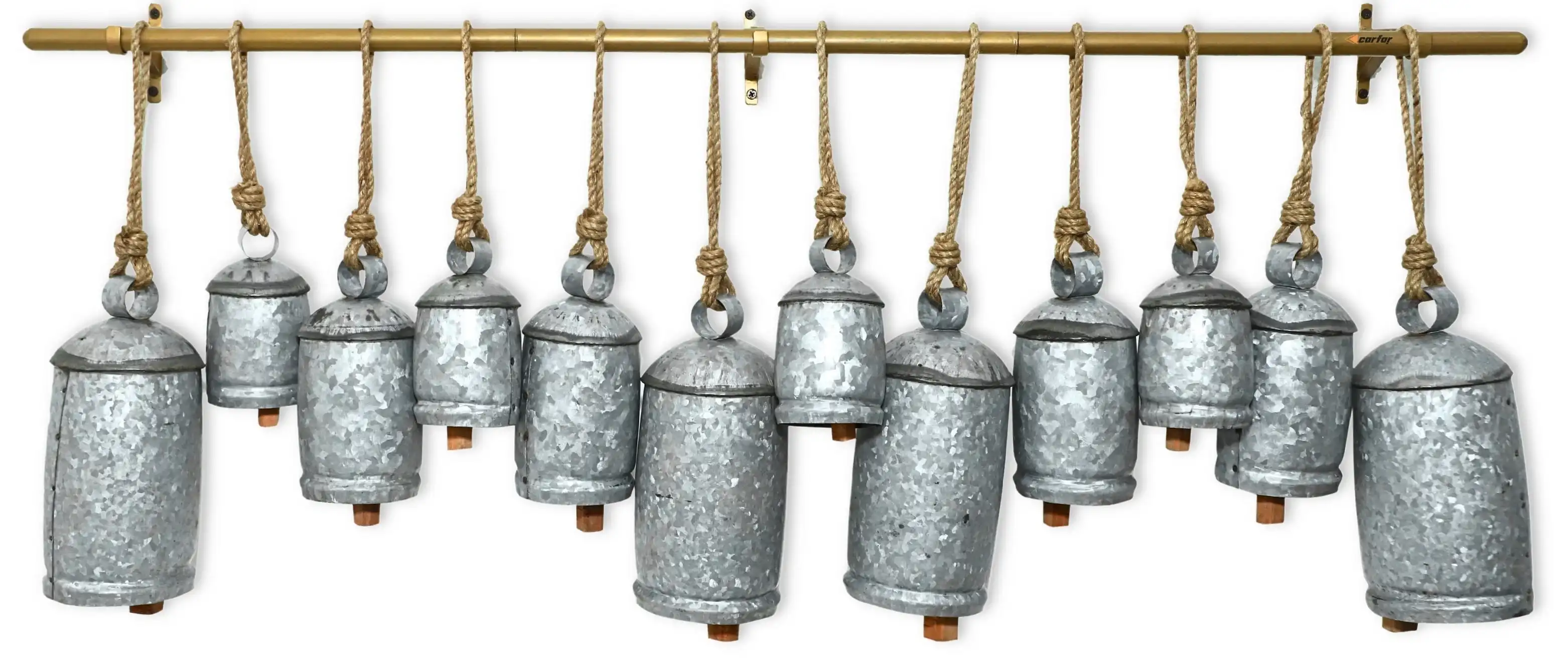 Traditional handmade metal bells grouped together with rustic golden patina