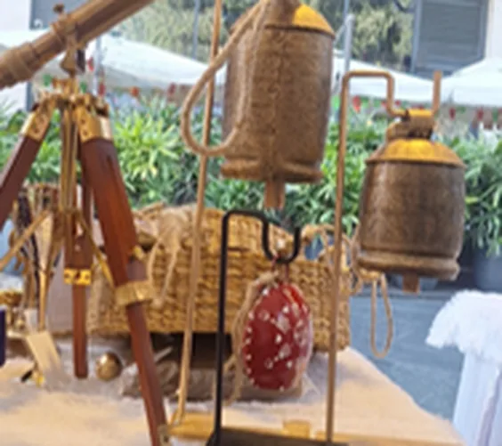 Handmade hanging bells for home and garden décor — bell clusters on a wooden display frame