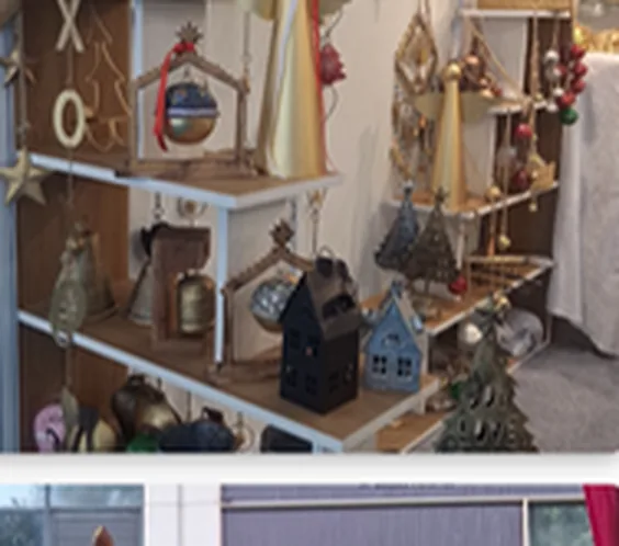 Retail display of handmade Indian metal décor, lanterns and hanging bells
